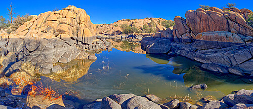 Reflective lagoon along East Bay Trail of Willow Lake, gray line on rock is where the water level used to be, Prescott, Arizona, United States of America, North America