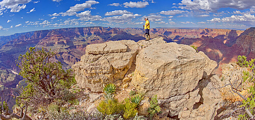 A hiker standing on a rock island at Pinal Point Grand Canyon, Grand Canyon National Park, UNESCO World Heritage Site, Arizona, United States of America, North America