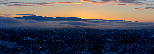 An ocean of fog rolling across the town of Chino Valley just as the sun is rising behind Mingus Mountain on a winter morning, Arizona, United States of America, North America