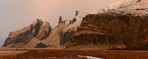 Panorama of mountain range and farm at sunrise, Iceland, Polar Regions