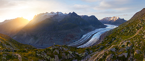 Panoramic and aerial view of trekker at Aletsch Glacier during sunset in summer, Riederalp, Oriental Raron, Valais, Switzerland, Europe