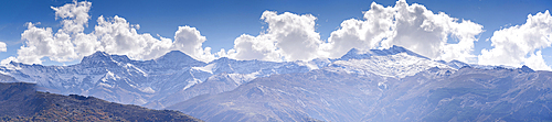 Panoramic view of the snowy sierra nevada with Alcazaba, Mulhacen and Pico de Veleta. View from Güejar Sierra, Sierra Nevada, Granada, Spain