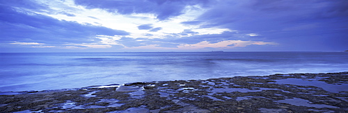 View across North Sea towards Farne Islands at dusk, from Bamburgh, Northumberland (Northumbria), England, United Kingdom, Europe