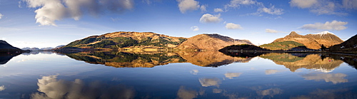 Panoramic view of Loch Levan in flat calm conditions with perfect reflections of distant mountains including Pap Of Glencoe, Glencoe Village, Highland, Scotland, United Kingdom, Europe