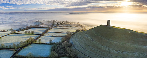 Aerial view by drone of frosty winter morning at Glastonbury Tor, Somerset, England, United Kingdom, Europe