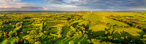 Aerial panorama of Glastonbury Tor and surrounding rolling countryside, Somerset, England, United Kingdom, Europe