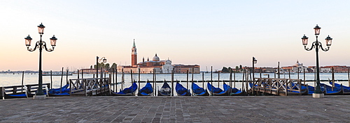 Gondolas moored on the Lagoon, San Giorgio Maggiore beyond, Riva degli Schiavoni, Venice, UNESCO World Heritage Site, Veneto, Italy, Europe