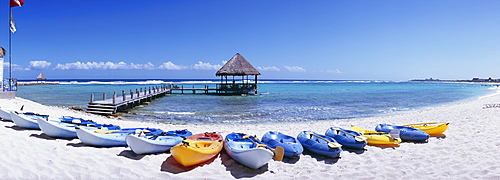 Kayaks on the beach and pier with palapa jutting out into the water from the beach, Mayan Riviera, Akumal, Yucatan, Quintana Roo, Mexico, North America