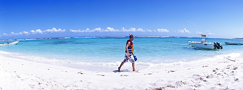 Teenager with snorkle equipment walking along the beach, Mayan Riviera, Akumal, Yucatan, Quintana Roo, Mexico, North America