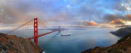 Panoramic view of the Golden Gate Bridge at sunset with a rainbow and storm clouds, San Francisco, California, United States, North America