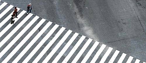 Shibuya Crossing, intersection, three people cross long crosswalk, Shibuya, Udagawacho, Tokyo, Japan, Asia