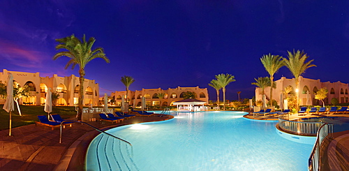 Swimming pool with palm trees at sunset, Hilton Nubian Resort, Al Qusair, Marsa Alam, Egypt, Africa