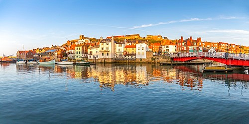 View of St. Mary's Church and reflections on River Esk at sunset, Whitby, Yorkshire, England, United Kingdom, Europe