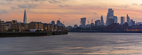 View of The City skyline at sunset from the Thames Path, London, England, United Kingdom, Europe