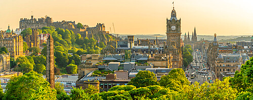 View of Edinburgh Castle, Balmoral Hotel and Princes Street from Calton Hill at golden hour, Edinburgh, Lothian, Scotland, United Kingdom, Europe