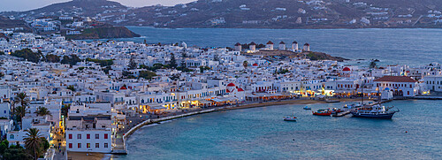 View of windmills and town from elevated view point at dusk, Mykonos Town, Mykonos, Cyclades Islands, Greek Islands, Aegean Sea, Greece, Europe