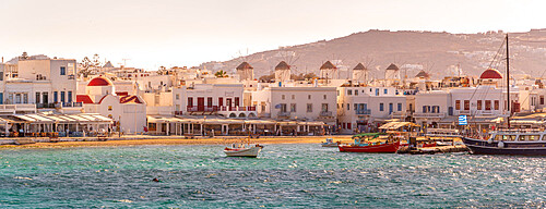 View of windmills overlooking town and harbour at golden hour, Mykonos Town, Mykonos, Cyclades Islands, Greek Islands, Aegean Sea, Greece, Europe