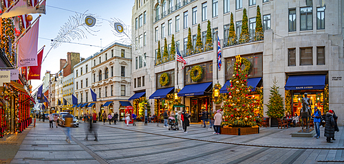 View of Christmas decorations, Christmas tree and shops on New Bond Street at Christmas, London, England, United Kingdom, Europe