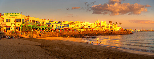 View of beach and cafes and bars during golden hour, Playa Blanca, Lanzarote, Canary Islands, Spain, Atlantic, Europe