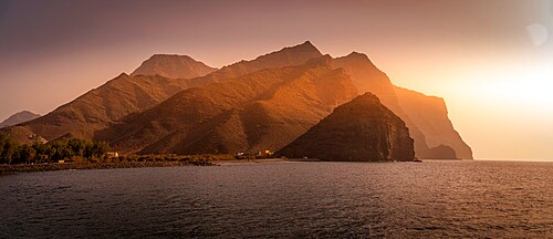 View of coastline and mountains in background during golden hour, Puerto de La Aldea, Gran Canaria, Canary Islands, Spain, Atlantic, Europe