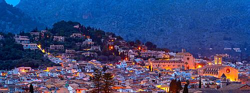 View of churches and rooftops of Pollenca with mountain in background at dusk, Pollenca, Majorca, Balearic Islands, Spain, Mediterranean, Europe