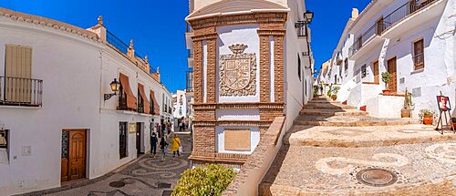 View of white washed houses and shoppers on narrow street, Frigiliana, Malaga Province, Andalucia, Spain, Europe