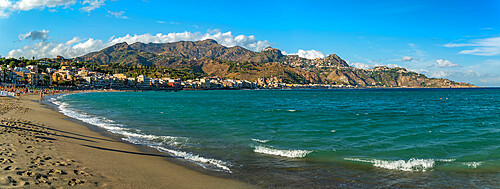 View of Taormina and Castelmola viewed from beach at Giardini Naxos, Sicily, Italy, Mediterranean, Europe