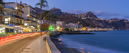 View of Taormina and Giardini Naxos promenade viewed from Giardini Naxos at dusk, Sicily, Mediterranean, Italy, Mediterranean, Europe