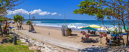 View of vendors and surf boards on sunny morning on Kuta Beach, Kuta, Bali, Indonesia, South East Asia, Asia