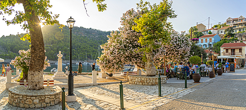 View of harbourside restaurant and colourful houses in Assos in golden hour, Assos, Kefalonia, Ionian Islands, Greek Islands, Greece, Europe