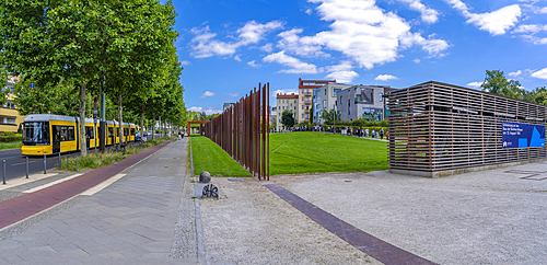 View of yellow city tram at the Berlin Wall Memorial, Memorial Park, Bernauer Strasse, Berlin, Germany, Europe