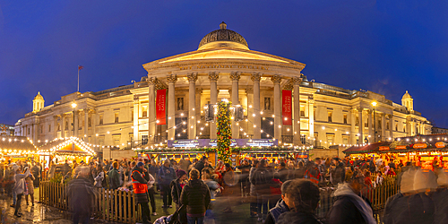 View of Christmas market and The National Gallery in Trafalgar Square at dusk, Westminster, London, England, United Kingdom, Europe