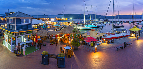 View of boats and restaurants at Knysna Waterfront at dusk, Knysna, Garden Route, Western Cape, South Africa, Africa