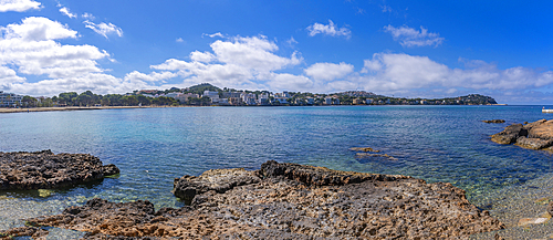 View of rocky shoreline by turquoise sea and Santa Ponsa, Majorca, Balearic Islands, Spain, Mediterranean, Europe