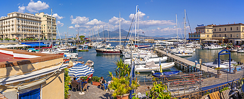 View of boats in harbour, restaurants and Mount Vesuvius from Ovo Castle, Naples, Campania, Italy, Europe