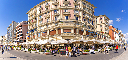 View of pastel coloured architecture, restaurants and cafes on seafront of Via Partenope, Naples, Campania, Italy, Europe