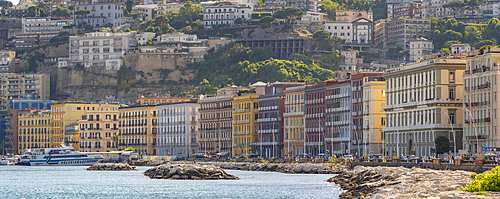 View of pastel coloured architecture on waterfront of Via Francesco Caracciolo, Naples, Campania, Italy, Europe