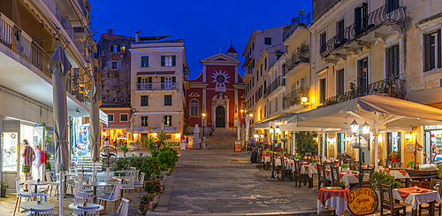 View of restaurants in Mitropolis Square, old Corfu Town at dusk, UNESCO World Heritage Site, Corfu, Ionian Sea, Greek Islands, Greece, Europe