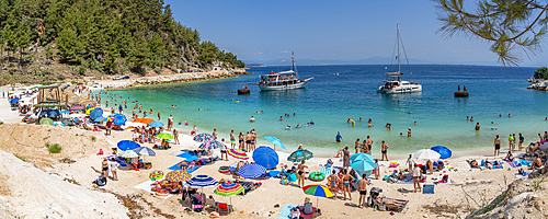 View of beach scene and boat on the sea at Porto Vathy, Makriammos, Thassos, Aegean Sea, Greek Islands, Greece, Europe