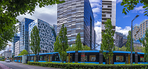 View of city tram and contemporary architecture in the Barcode area on a sunny day, Oslo, Norway, Scandinavia, Europe