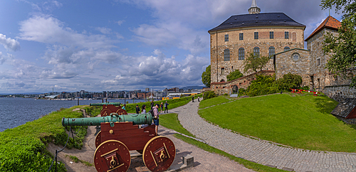 View of the Akershus Fortress, cannons and city skyline from inside the walls on a sunny day, Oslo, Norway, Scandinavia, Europe