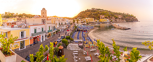 Elevated view of beach and the town of Lacco Ameno at sunset, Island of Ischia, Campania, Italy, Europe