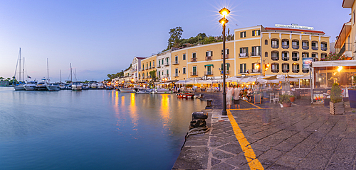 View of restaurants in Porto d'Ischia (Port of Ischia) at dusk, Island of Ischia, Campania, Italy, Europe