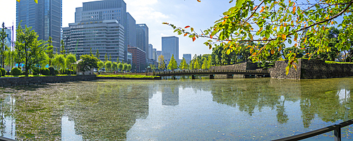 View of reflections in Wadakura Moat on a sunny day, Chiyoda, Tokyo, Honshu, Japan