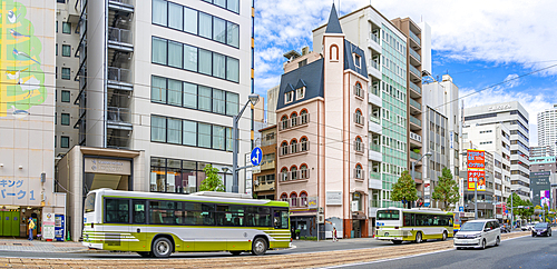 View of city buses on major street during daytime, Hondori, Naka Ward, Hiroshima, Honshu, Japan