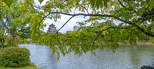 View of Hiroshima Castle, with museum, reflecting in Moat, Motomachi, Naka Ward, Hiroshima, Honshu, Japan