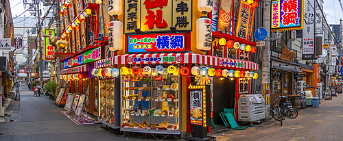 View of colourful facades of shops and restaurants in Dotonbori, vibrant entertainment district near the river, Osaka, Honshu, Japan