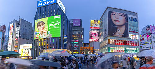 View of colourful adverts in Dotonbori, vibrant entertainment district near the river at dusk, Osaka, Honshu, Japan