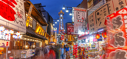 View of Tsutenkaku Tower and restaurants neon lights at dusk in the Shinsekai area, Osaka, Honshu, Japan