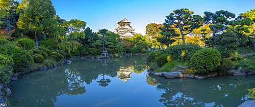 View of Osaka Castle reflecting in Japanese garden pond at sunset, Osakajo, Chuo Ward, Osaka, Honshu, Japan, Asia